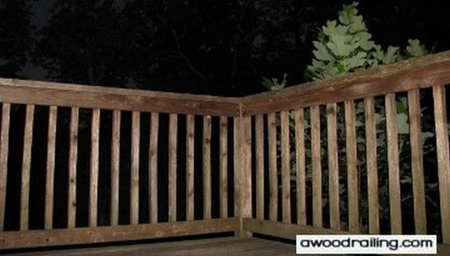 A classic deck handrail design featuring traditional pressure-treated lumber with 2x4 horizontal rails and 2x2 balusters