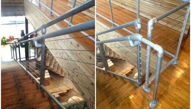 A modern deck railing design featuring metal pipe support posts with cable wire railings, creating a unique and interesting look for outdoor spaces