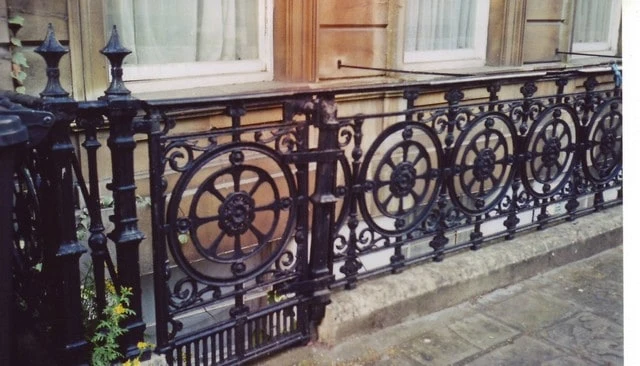 Ornate wrought iron railings featuring a custom guard rail design with economical repeating patterns for enhanced aesthetic in deck railing design.
