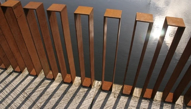 Rectangular metal box railing featuring an artistic balustrade design, perfect for enhancing industrial-chic outdoor spaces in deck railing design.