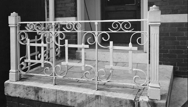 Front porch railing design featuring a combination of square forms and spirals arranged in a "#" symbol shape for creative deck railing design.