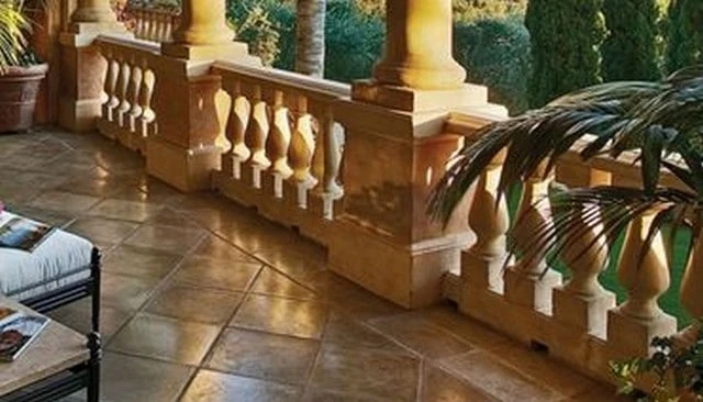 Simple stone balusters in Grecian urn style featuring a larger diameter at the bottom, narrowing and flaring at the top for classic deck railing design.