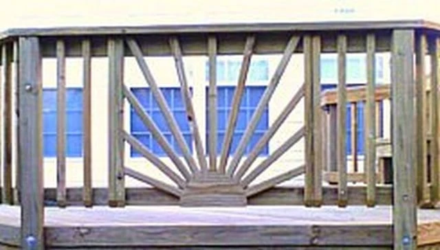 Wooden deck railing idea featuring a sunburst design with vertical 2x2 balusters and a jigsaw cut circular piece representing the sun for deck railing design.