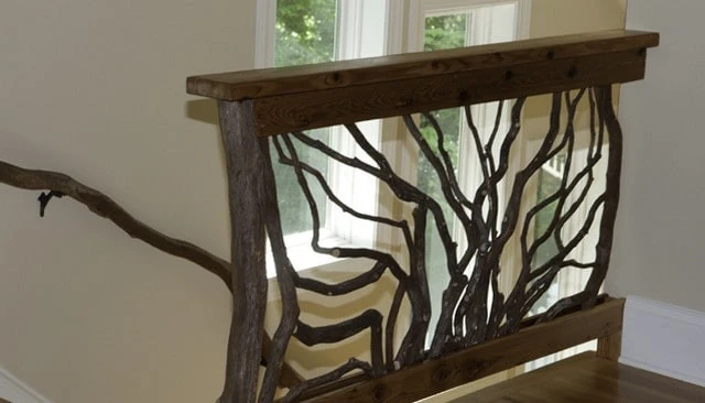 Mountain laurel handrail in sunburst style featuring branch design, complementing a sunlit window for a warm aesthetic in deck railing design.