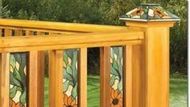 Tiffany style stained glass balusters integrated with wood top and bottom rails and matching post cap, creating a vibrant and artistic deck railing design.