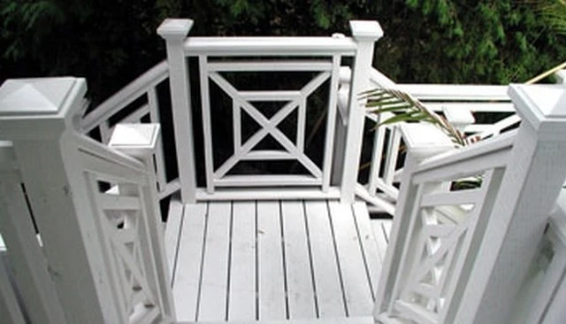Geometric X pattern Chippendale handrail featuring precision-cut diagonal crossings, showcasing expert craftsmanship in modern mountain home design for deck railing design.