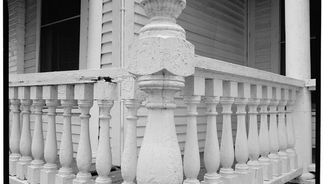 Historic balustrade design featuring elegant turned balusters with square bases, showing signs of decay, dating before 1933.