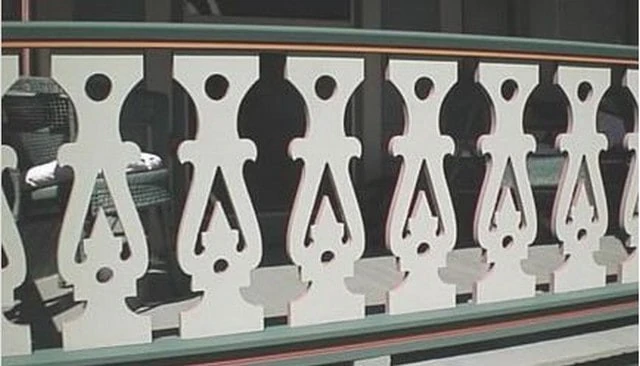 sawn baluster handrail featuring multi-colored balusters with intricate patterns, providing distinctive appeal for outdoor spaces.