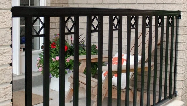 Black metal handrail design featuring vertical balusters spaced every 3 inches with diamond inserts at alternating openings, ideal for contemporary deck railing designs.