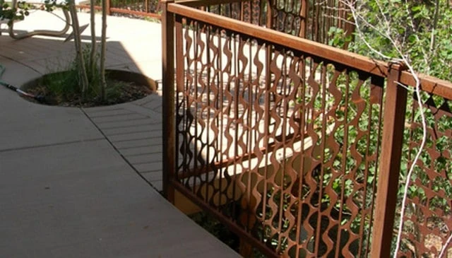 Dynamic deck handrails featuring jaggedly curved metal balusters combined with thin balusters, creating a waterfall effect in motion for innovative deck railing designs.