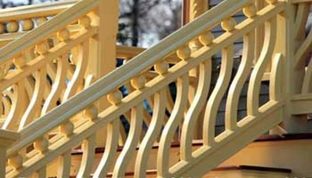 Stair railings featuring gracefully curved wavy balusters with spheres, creating a rhythmic flow and artistic aesthetic.