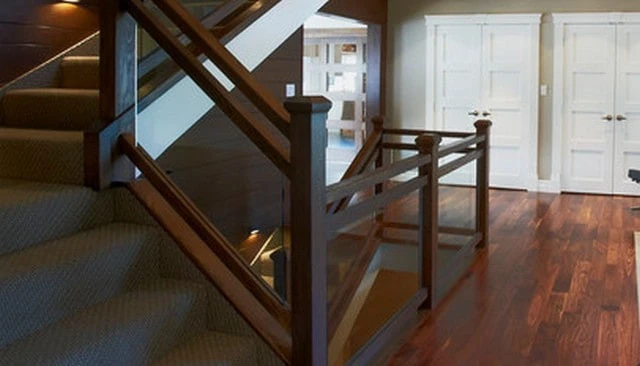 Craftsman style glass panel railing featuring double top with stained chestnut brown wood posts and rails, ideal for elegant deck railing designs.