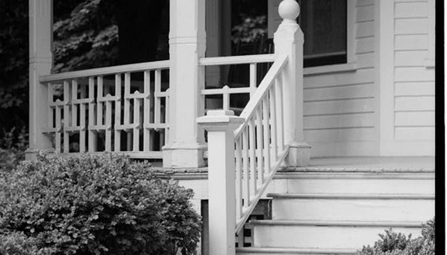 A historic deck design idea featuring vertical 2x2s with wide expanses of space, showcasing unique deck railing designs.