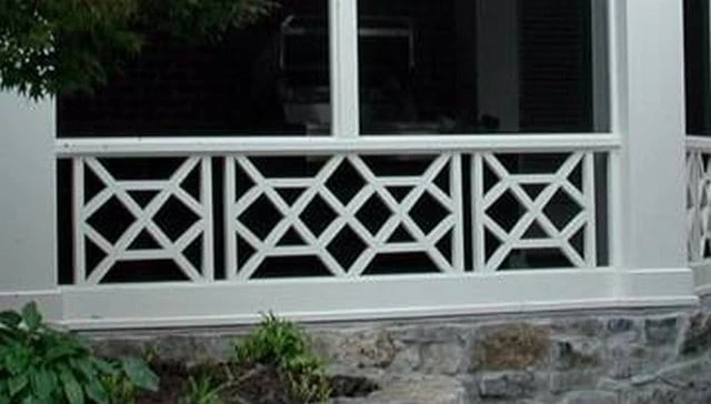 A distinctive home railing featuring a classic X-eye Chippendale pattern with a handcrafted wooden balustrade and captivating oval centerpiece, ideal for elegant deck railing designs.