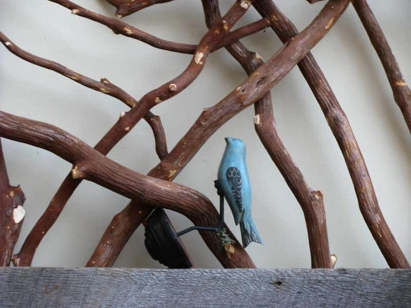 Rustic barnwood railing adorned with decorative birds clamped on