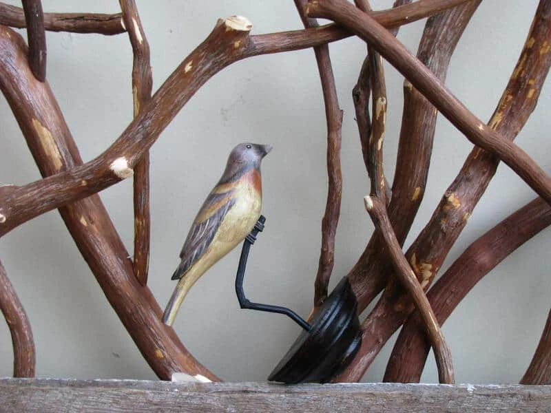 Rustic barnwood railing adorned with decorative birds clamped on