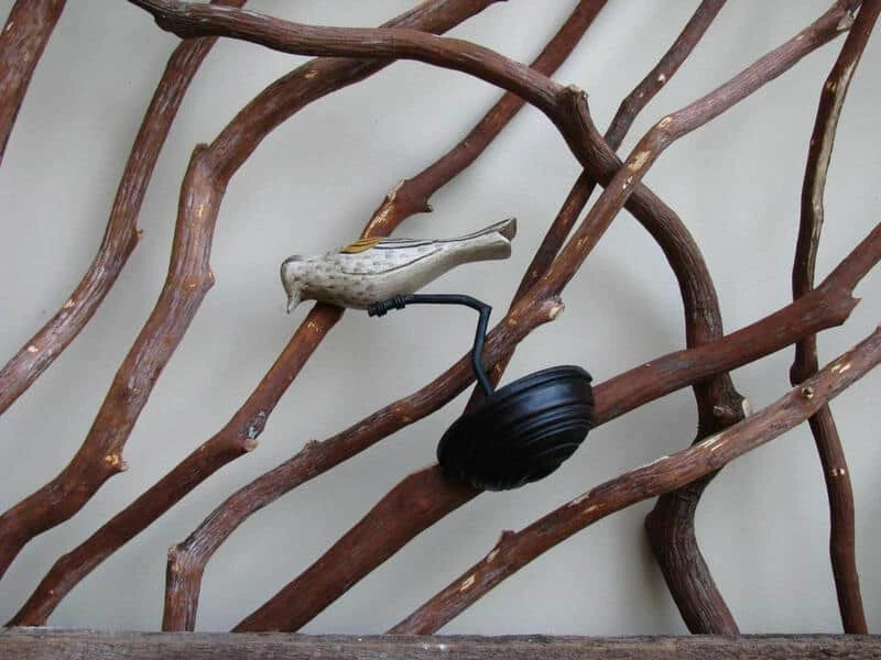 Rustic barnwood railing adorned with decorative birds clamped on