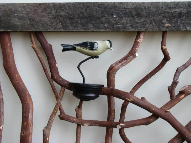 Rustic barnwood railing adorned with decorative birds clamped on