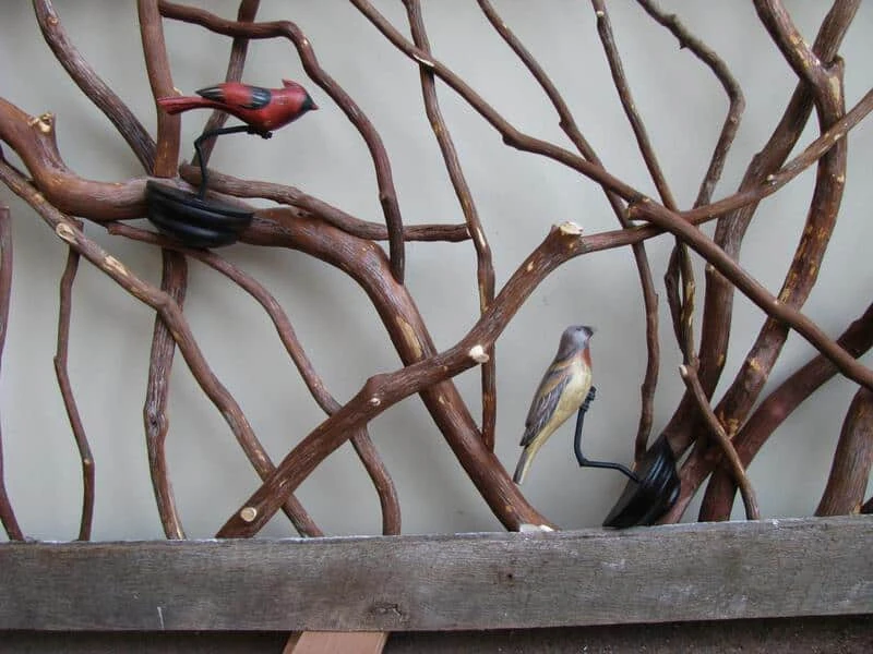 Rustic barnwood railing adorned with decorative birds clamped on