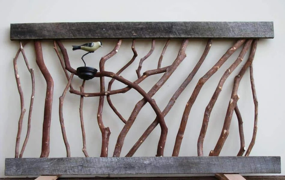 Rustic barnwood railing adorned with decorative birds clamped on