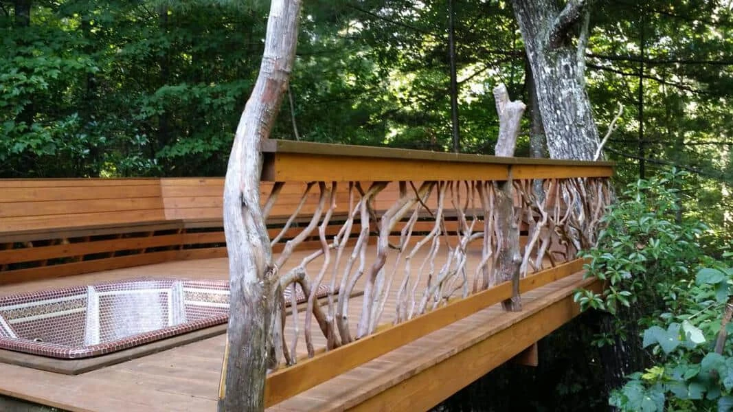 Mountain laurel handrails surrounding a built-in hot tub on a deck