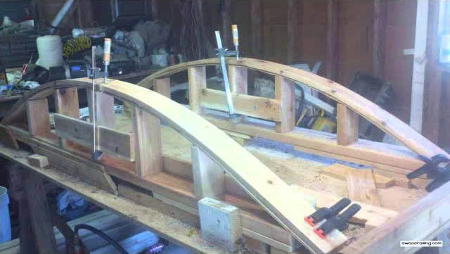 Curved railing under construction showcasing the craftsmanship and design techniques involved in creating elegant outdoor railings.