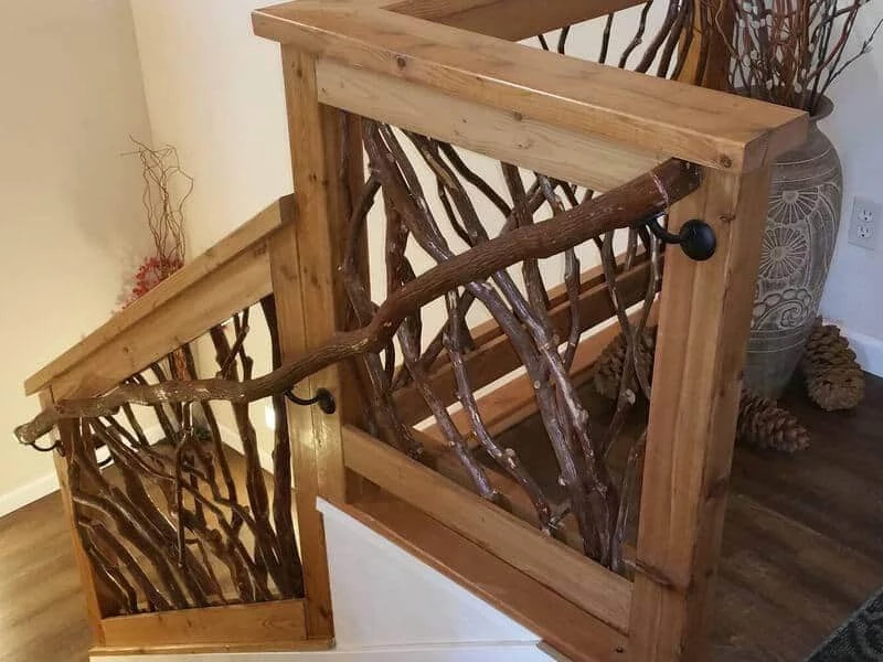 A branch banister seamlessly attached to Mountain Laurel handrails on a staircase, showcasing natural wood textures.