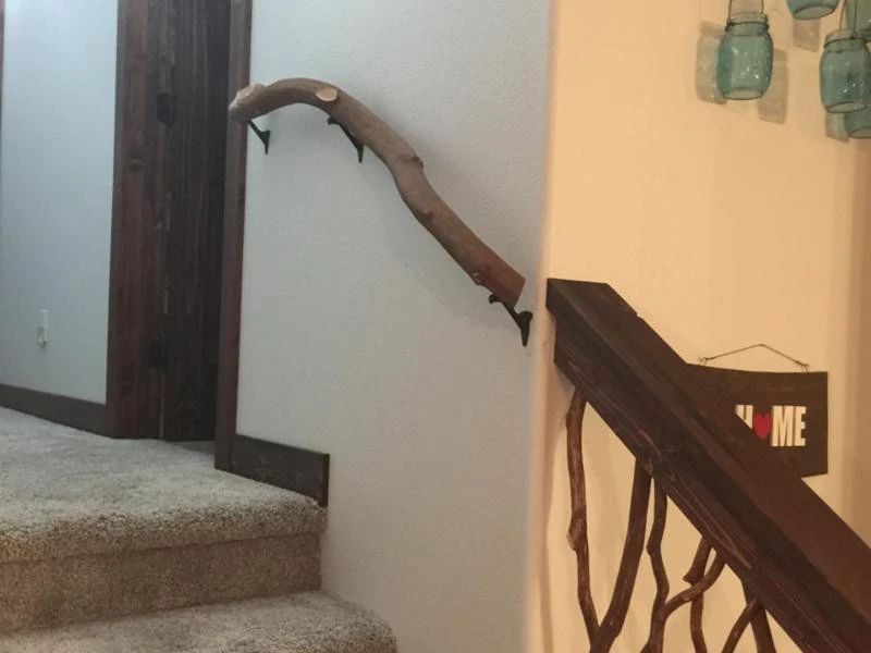 A branch banister elegantly leading to Mountain Laurel stair handrails, showcasing a seamless transition between natural designs.