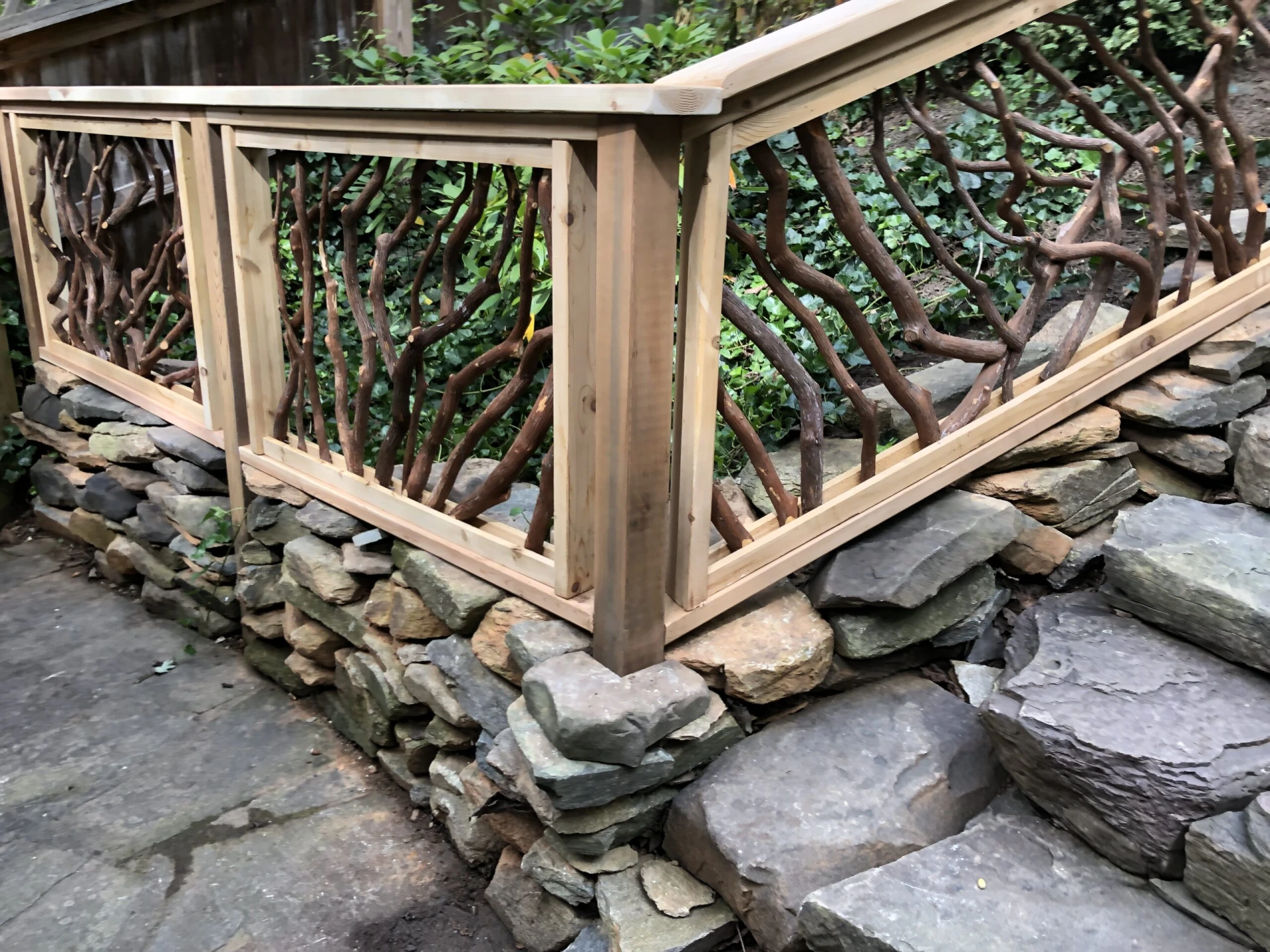 Close-up view of the Lissara style handrail on the corner post at the bottom of the staircase, transitioning into a regular handrail.