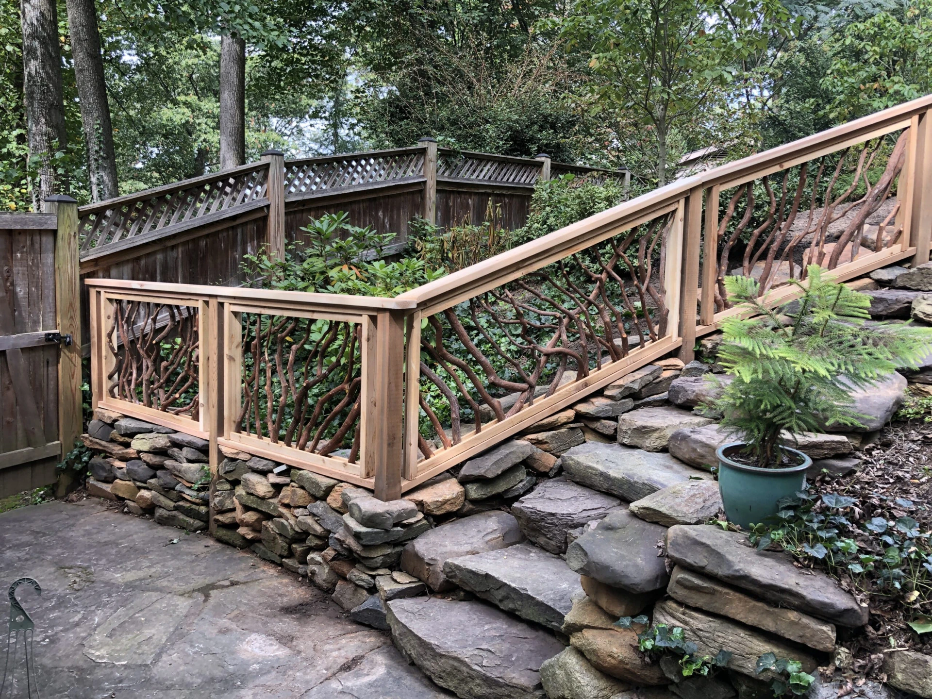 Elegant Lissara style handrails adorning an outdoor stone staircase, showcasing a blend of sophistication and durability.