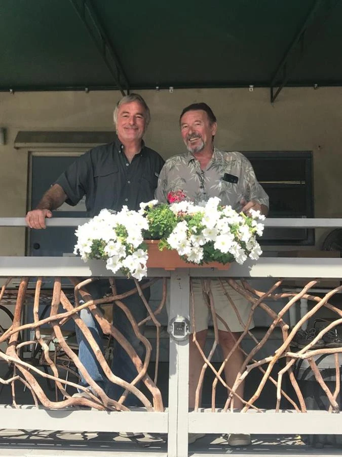 Fort Lauderdale Fl Men Posing Infront Handrails With Flowers