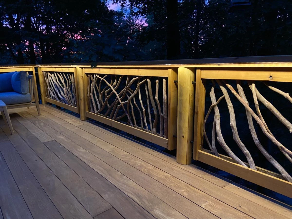 Mountain Laurel railings illuminated at night, showcasing their intricate design and adding a warm glow to the outdoor space.