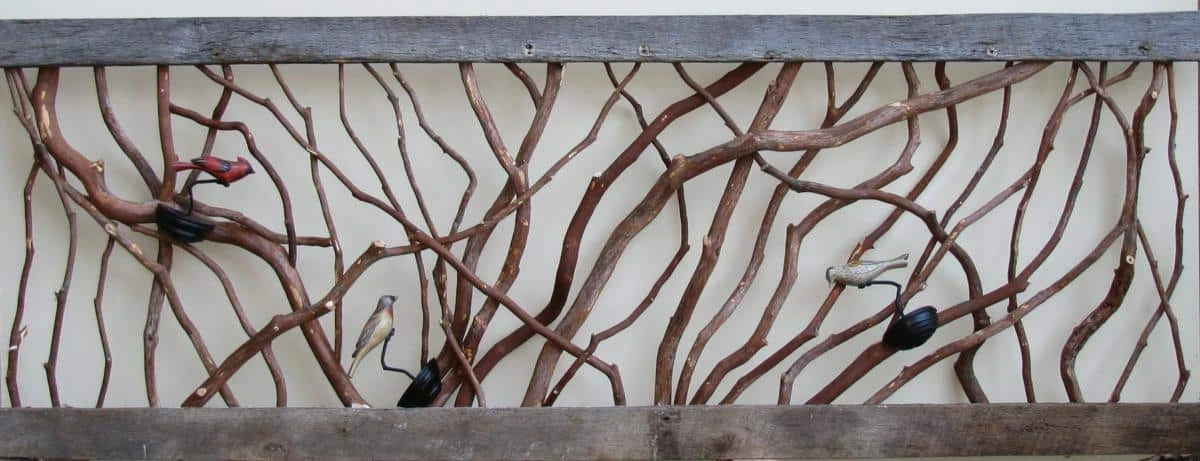 Rustic barnwood railing adorned with decorative birds clamped on