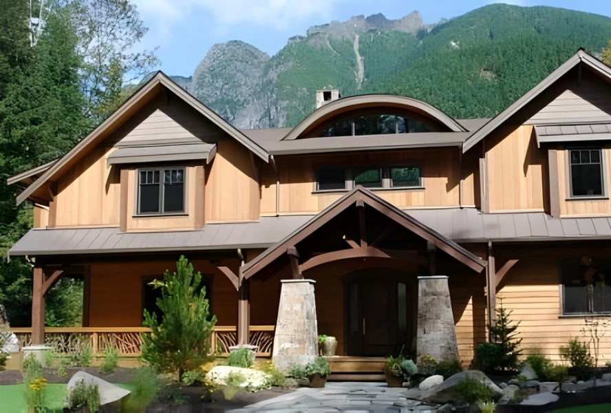 Exterior view of a modern wooden house with a mountain backdrop, featuring a porch with woven branch railing and landscaped garden.