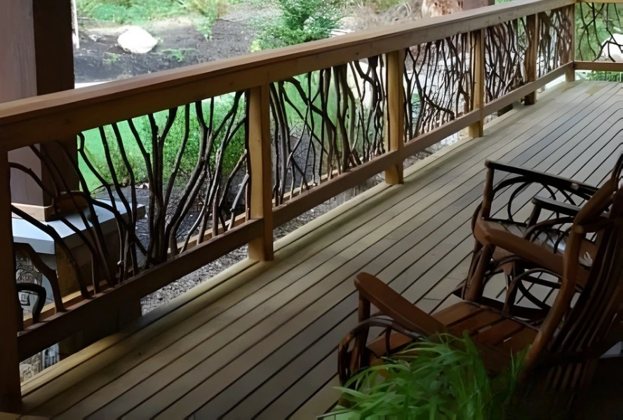 Wooden deck with handcrafted woven branch railing, wooden chairs, and a potted plant, overlooking a green garden.